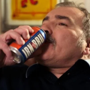 man drinking IRN BRU out the can
