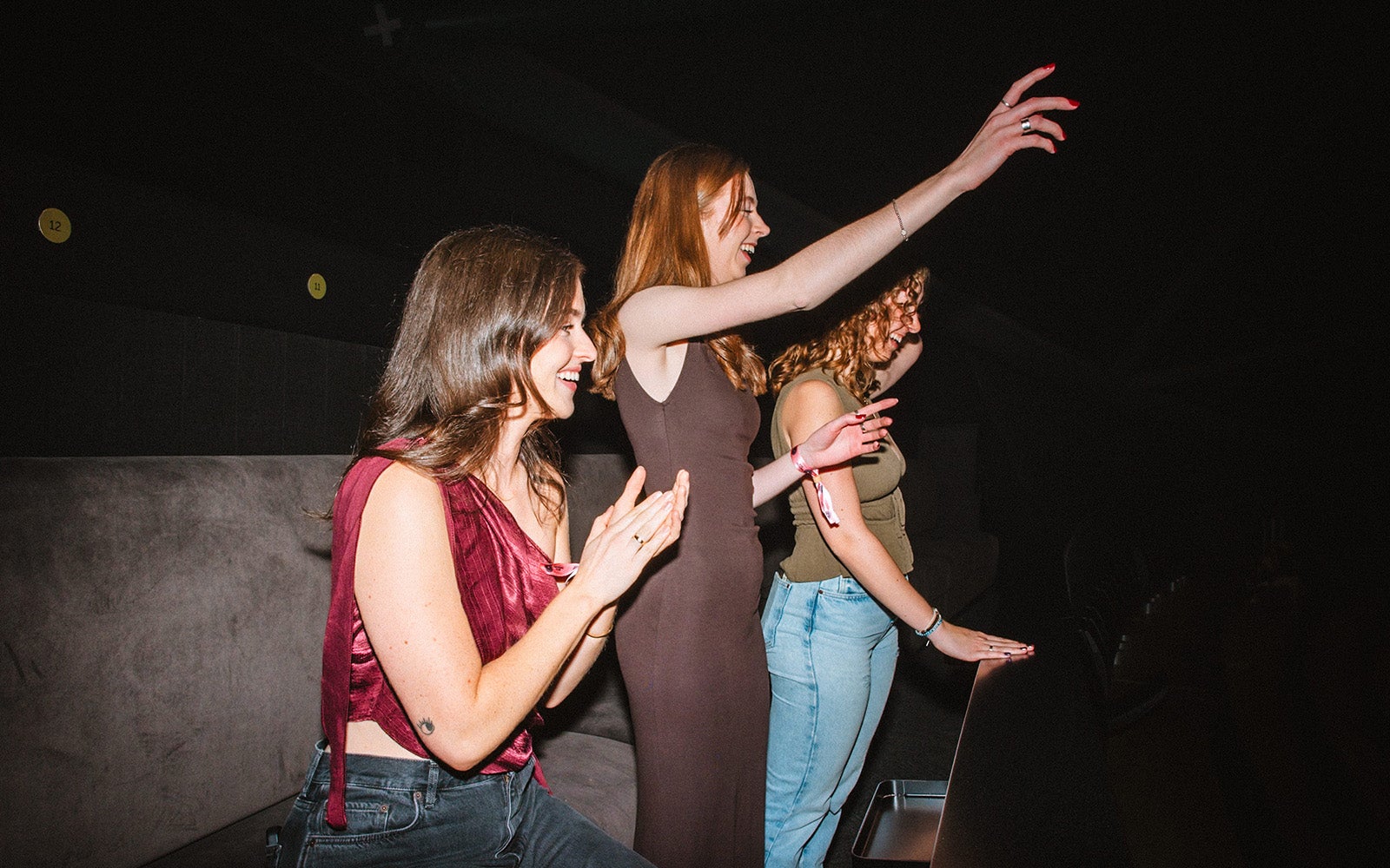 Three women at The Nest dancing at a gig.