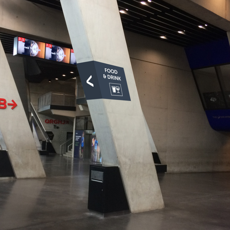 Inside of the OVO Hydro with sign pointing towards food and drink