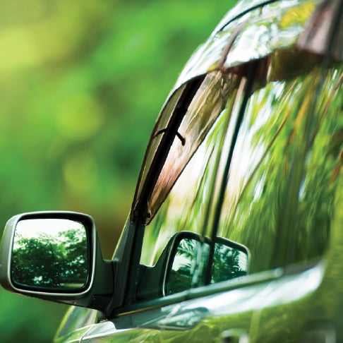 Small section of a car and wing mirror.