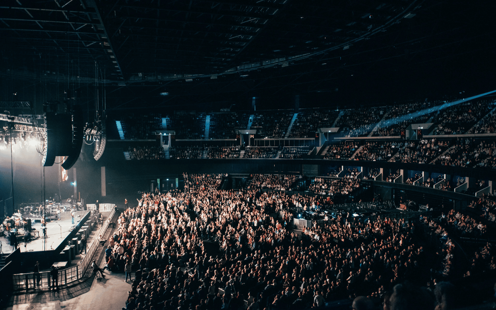 Artist performing on stage at the OVO Hydro with view on the standing and seated crowd.