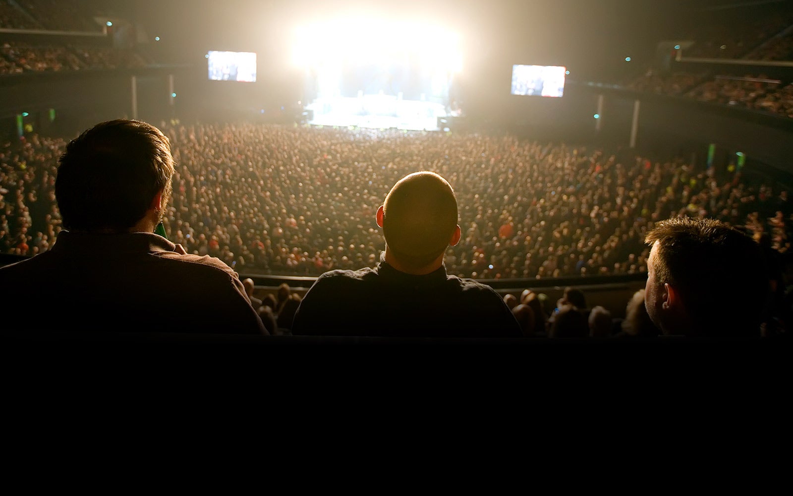 Image looking onto people in the crowd at a concert at the OVO Hydro.