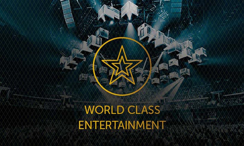 View of a show stage set up - boxes hanging from the ceiling - with World Class Entertainment text and icon overlay.
