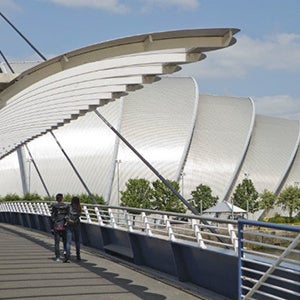 People walking over the bridge to the SEC Armadillo.